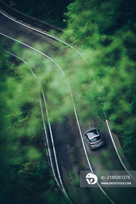 Car on a mountain road in a cloudy day Concept of life on the road and travel all weather