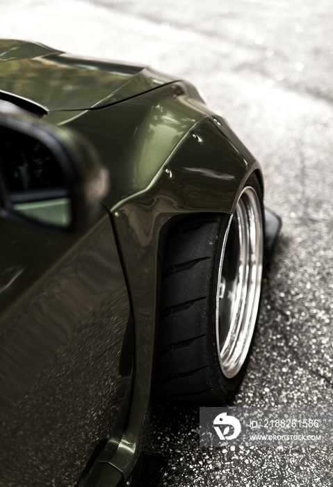 Passenger side of the car showing a widebody kit on the front fender