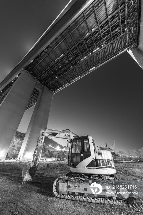 excavator in construction site at night