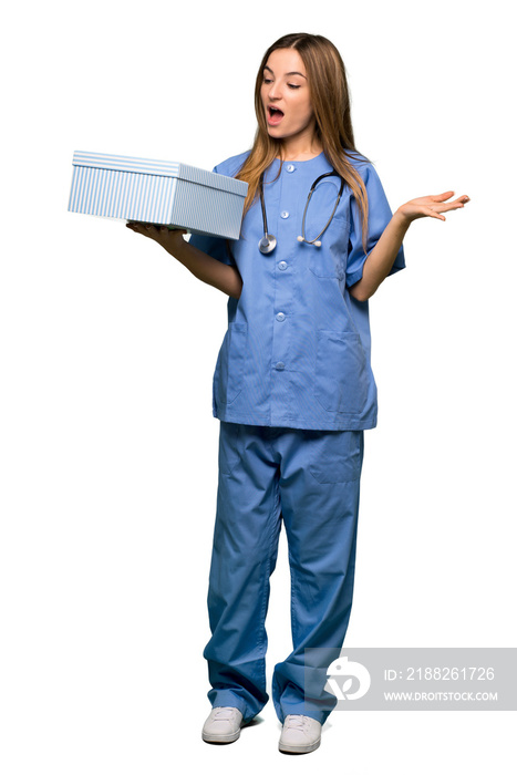 Full body Young nurse holding gift box in hands on isolated background