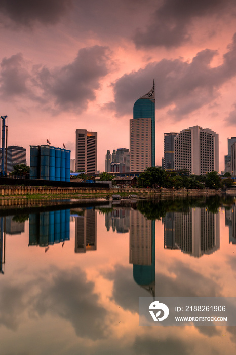 A view of office buildings in Jakarta at dusk under an overcast sky