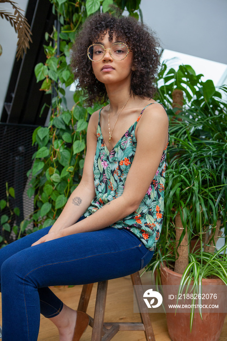 Portrait of woman surrounded with houseplants