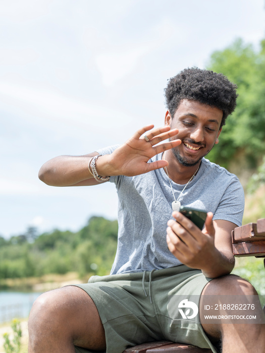 Smiling man during video call on sunny day