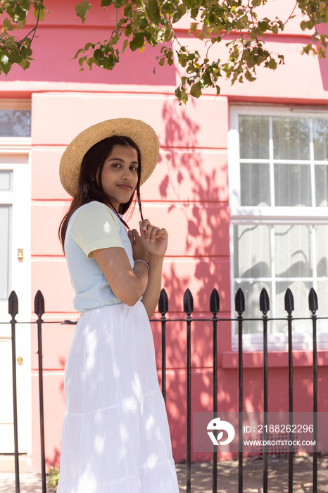 Portrait of smiling young woman in sun hat