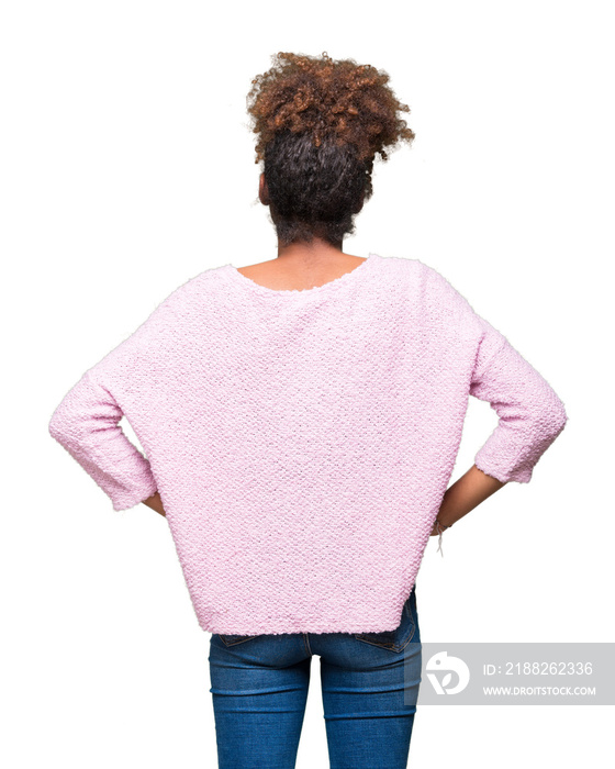 Beautiful young african american woman wearing glasses over isolated background standing backwards looking away with arms on body