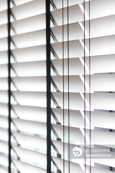 White wooden window blinds, selective focus image.