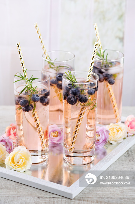 Cold shot in glass with blueberry, ice cubes, rosemary. Celebratory inspiration in Provence style