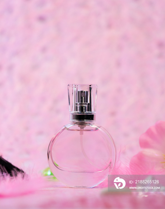 Bottle of perfume on pink background