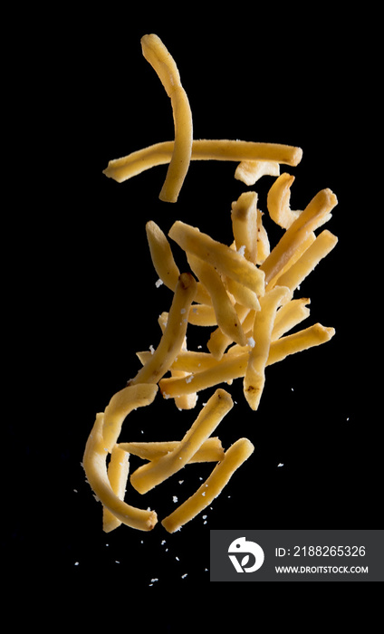 French fries with salt explode flying in the air isolated on black background,Stop motion