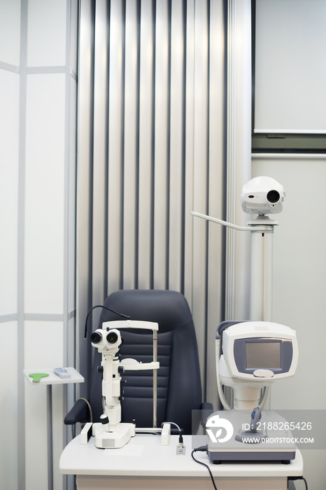 Vertical background image of modern optometric equipment in ophthalmology clinic, copy space