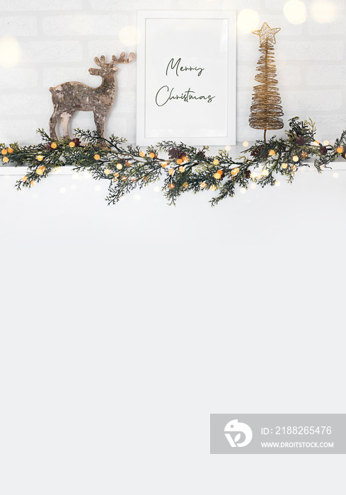 empty frame, reindeer and Christmas garland in white wall