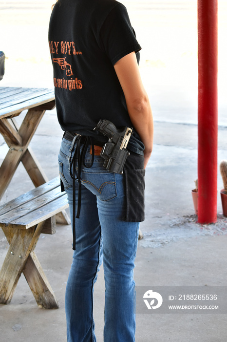 Portrait working waitress with open carry gun pistol