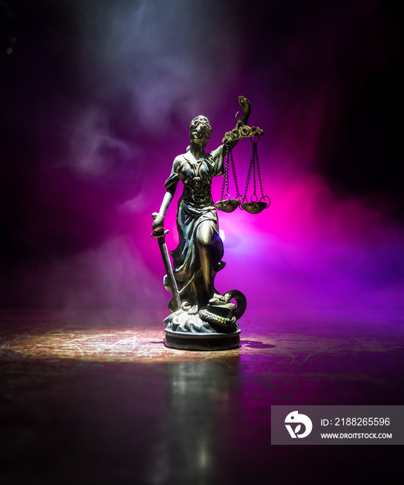 The Statue of Justice - lady justice or Iustitia / Justitia the Roman goddess of Justice on a dark fire background