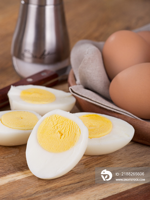 Sliced hard boiled eggs with brown eggs in background