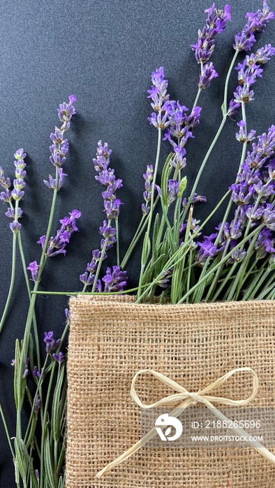 lavender on a gray background in a burlap bag