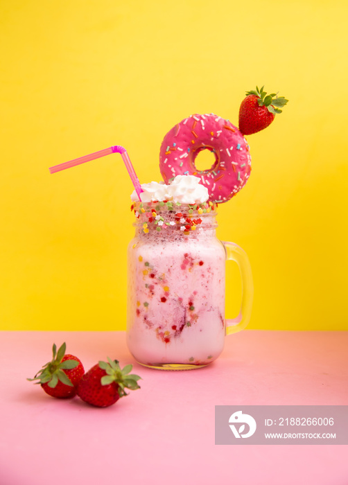 Delicious dessert strawberry smoothie with pink bagel and cream