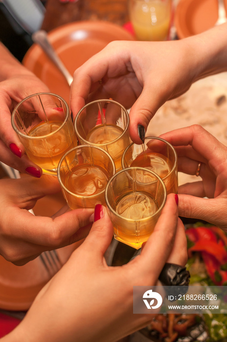 Close shot of girls clink glasses with shots