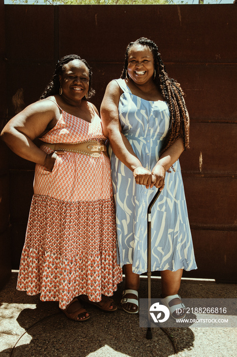 Full body 2 African American friends stand together outside