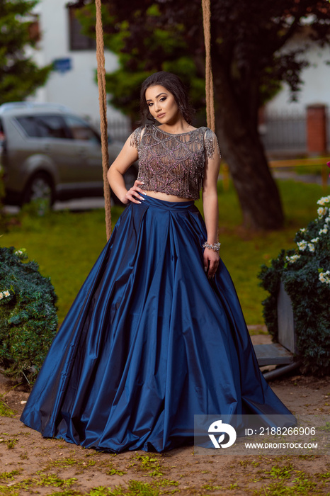 Beautiful young lady in luxury blue dress for her prom night