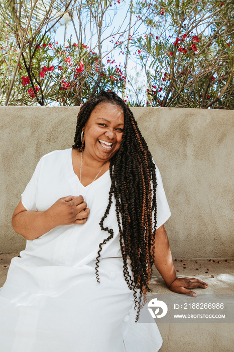 portrait of a plus size afro latinx haitian american woman sitting and laughing