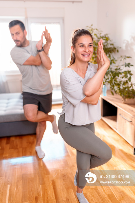 Couple doing yoga at home