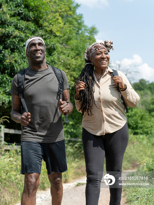 Smiling mature couple hiking in summer