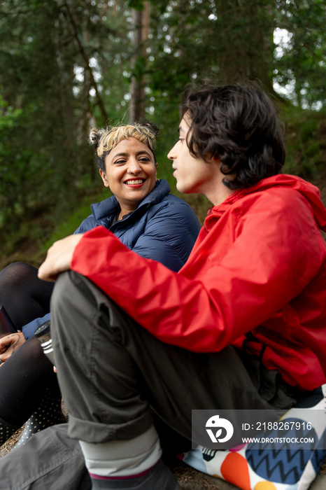 Mother and son relaxing in forest