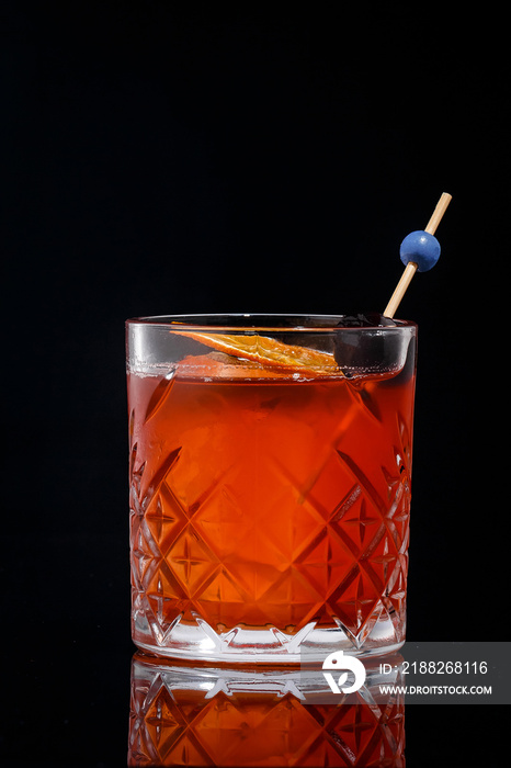 fresh cold cocktail with whiskey ice cube on black background