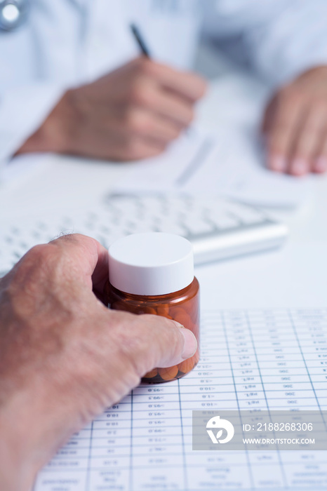 doctor prescribing pills to a senior man