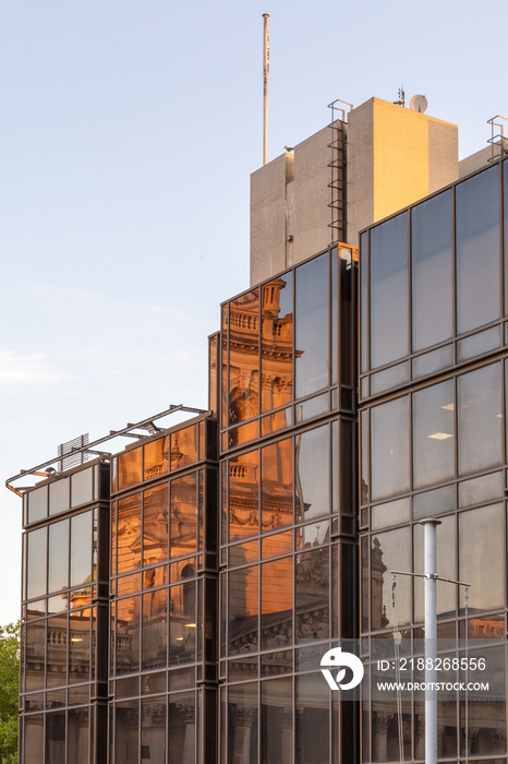 reflections of Portsmouth Guildhall in the Civic offices windows during sunrise