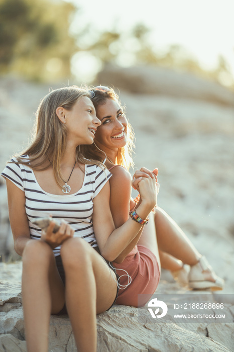 Two Female Friends Having Fun While Enjoying A Summer Vacation At The Beach