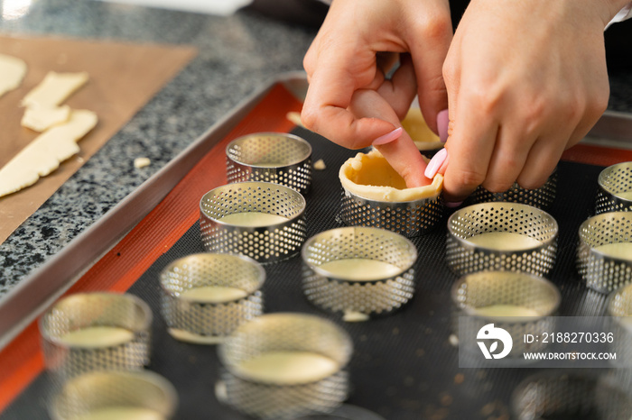 young girl chef makes desserts. bakes sweets and cakes. makes blanks and prepares fruits for the filling. baking, dessert, sweets, complex cooking processes.