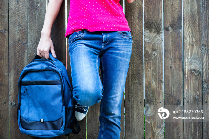 school kid feet in jeans and sneakers backpack  back to school