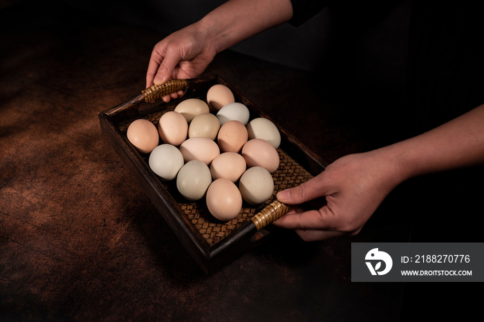 A woman’s hand holding an egg.