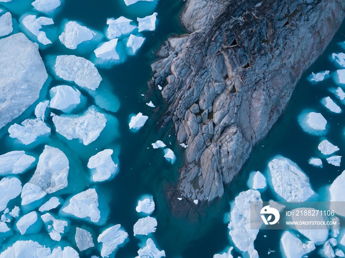 Icebergs drone aerial image top view - Climate Change and Global Warming. Icebergs from melting glacier in icefjord in Ilulissat, Greenland. Arctic nature ice landscape in Unesco World Heritage Site.