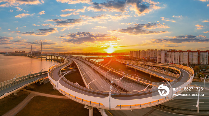 Saint Petersburg sunset. Automobile bridges in Russia. Overpass that turns into bridge in Saint Petersburg. Major road junction over city. Road construction in Petersburg. Road architecture of Russia