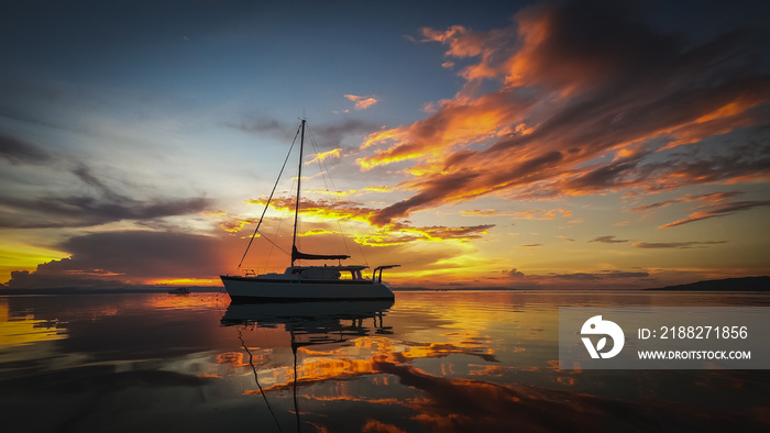 beautiful sunset in the sea with a sailboat