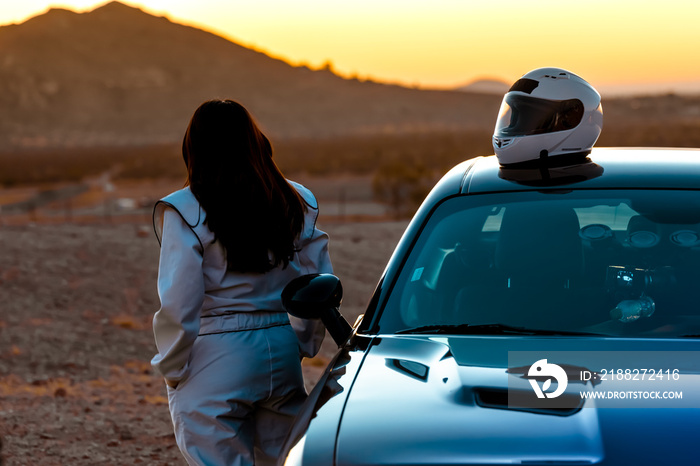 A Female Race Car Driver Watching The Sunrise Before Taking To The Track