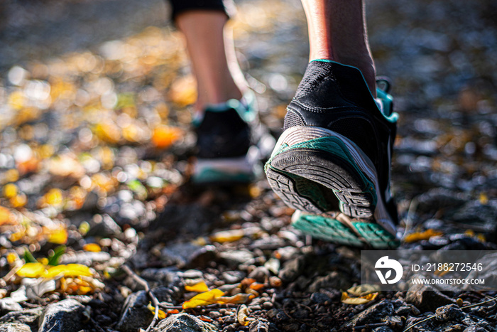 Closeup of footwear of a female runner getting ready for a trail run