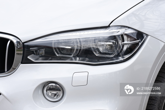 shiny headlight on a  white car