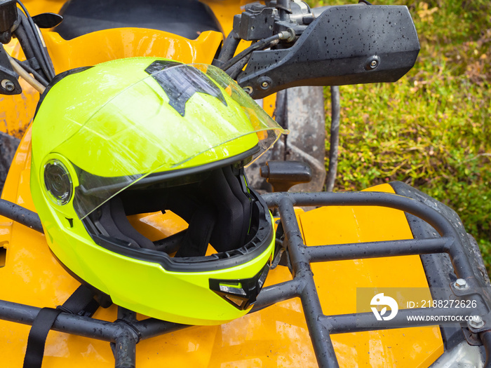 ATV helmet close up. Yellow protective ATV helmet. Concept is safety during motocross. ATV driver’s head protection. Driver’s head hemlet quad cycle. Equipment for extreme sports.