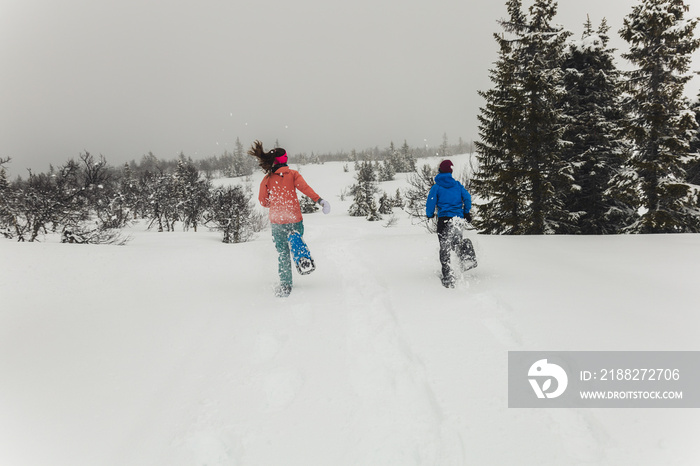 Running in the snow using snow shoes.