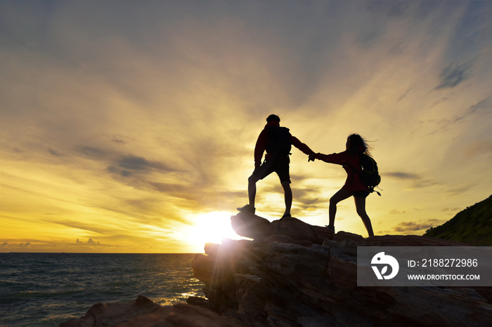 Young asian couple climbing.