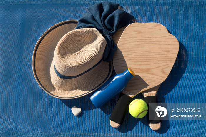 Summer accessories - hat, sun lotion and frescobol wooden paddles