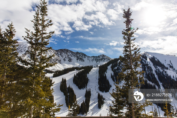 view of a ski resort in the mountains on a nice sunny day in winter