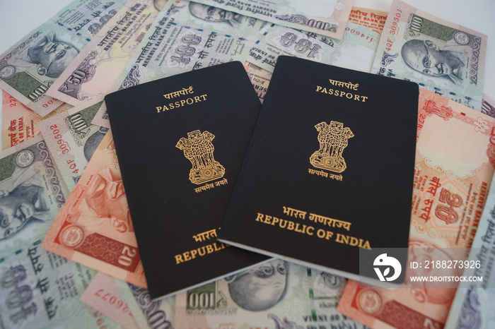 Indian passport with currency as background