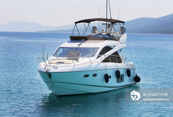 Luxury yacht in azure seas parked in a beautiful blue bay. Modern white Yacht in the sea around island on Croatia.