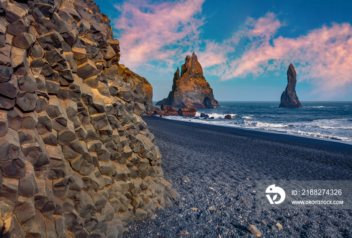 Frozen basalt hexagonal columns on the Atlantic coast. Black sand beach and Reynisdrangar cliffs. Gorgeous  summer scene of Iceland, Vik location, Europe. Beauty of nature concept background.