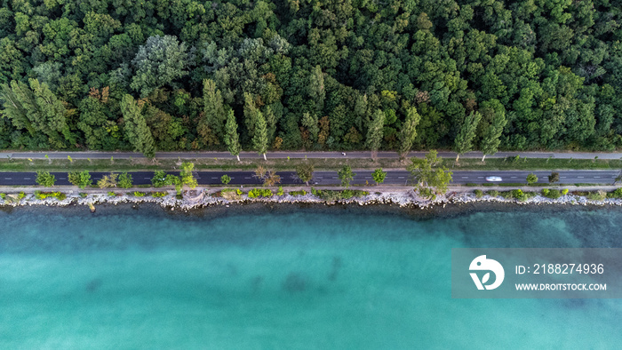 Arial view of a road next to a lake