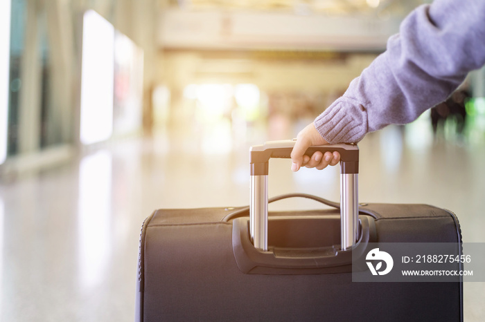 Young tourist walking and pull luggage at the airport